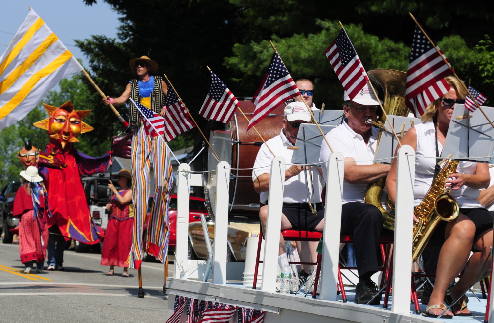 The Shoe String Theater group, left, follows the Hallowell Community Band as the 2014 Richmond Days parade heads down Main Street toward the Kennebec River. This year's Richmond Days runs Friday through Sunday with a Hawaiian theme.