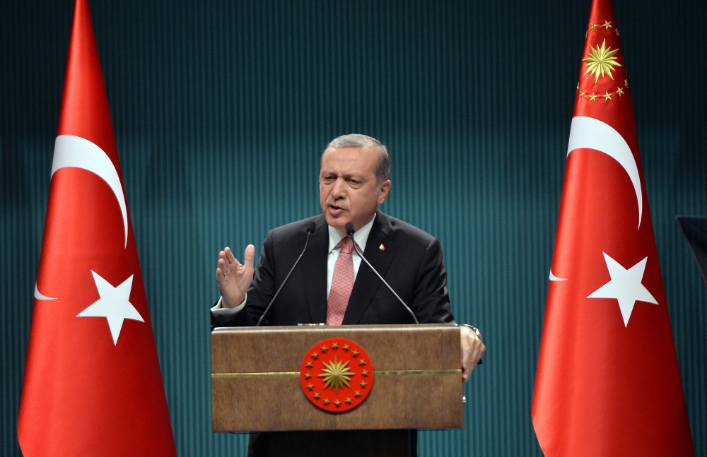Turkey's President Recep Tayyip Erdogan speaks after an emergency meeting of the government in Ankara, Turkey, late Wednesday. Erdogan on Wednesday declared a three-month state of emergency following a botched coup attempt, declaring he would rid the military of the "virus" of subversion and giving the government sweeping powers to expand a crackdown.
