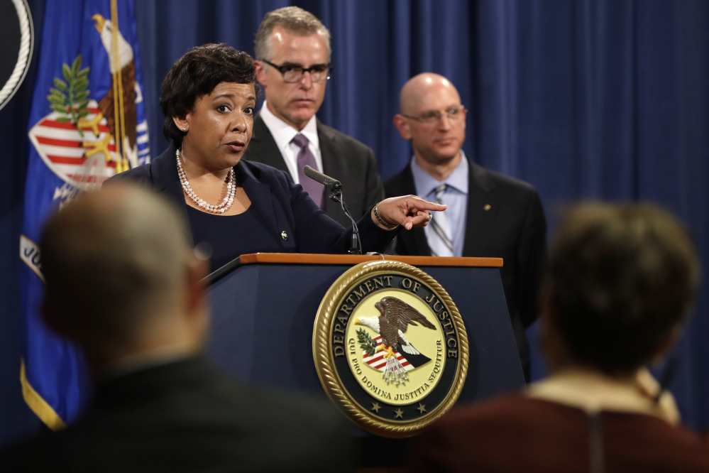 Attorney General Loretta Lynch, left, next to FBI Deputy Director Andrew McCabe and IRS Criminal Division Chief Richard Weber, speaks at a news conference, Wednesday, July 20, 2016, at the Justice Department in Washington, announcing that the U.S. government is seeking the forfeiture of more than $1 billion in assets that federal officials say were misappropriated from a Malaysian sovereign wealth fund. (AP Photo/Jacquelyn Martin)