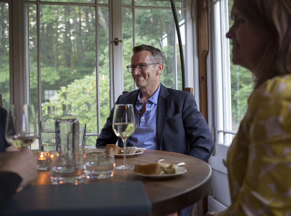 Above: Jeff Bell enjoys a dinner with friends at The Velveteen Habit in Cape Neddick. The restaurant in an old farmhouse has four acres of gardens out back. Left: A beet salad with strawberries, ricotta and olives.