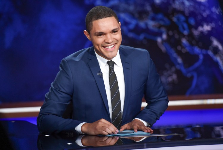 Trevor Noah at his "Daily Show" desk in New York. Observers say Noah is mixing comedy and opinion more lately than when he took over from Jon Stewart last year.