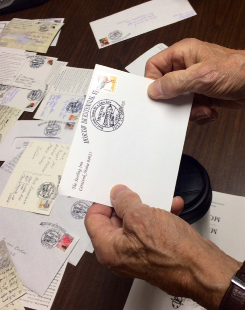 A visitor to Moscow holds an envelope stamped with the special pictorial postmark designed for the town's 200th anniversary celebration at the town's temporary post office Friday.