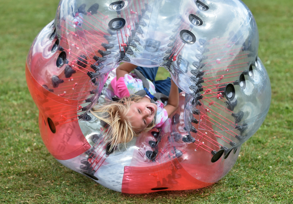 Kaydence McKenney, 6, seems to be having a rollicking good time in her knockerball during Oakfest at Williams Elementary School in Oakland on Saturday.