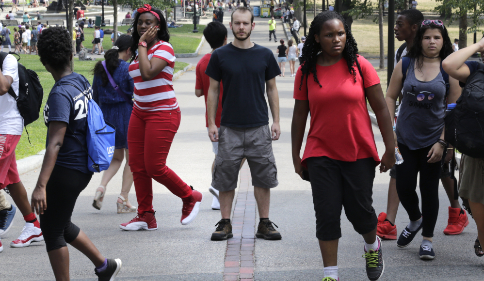 Colin Allen, creator of 'White Men for Black Lives,' stands on the Freedom Trail amid a group of summer-camp children in Boston, Mass. Some white Americans say they're being spurred to action after the shootings of black men by police officers.