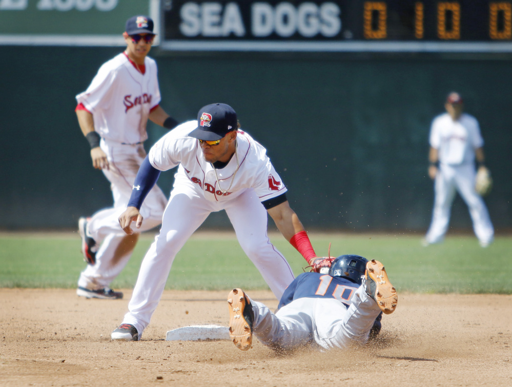 Binghamton's Champ Stuart jars the ball out of the glove of Sea Dogs second baseman Yoan Moncada as he slides in safely for a stolen base in the fifth inning Sunday at Hadlock Field. Stuart went on to score the winning run in a 2-1 victory.