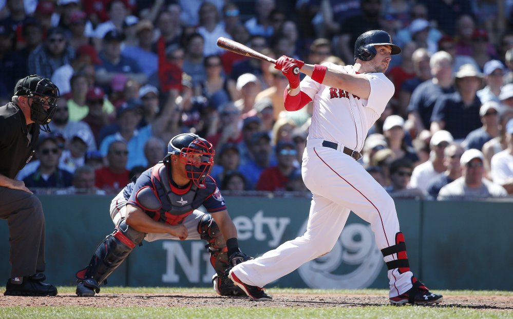 Travis Shaw follows through on a three-run homer in the fifth inning of the Red Sox' 8-7 win over the Minnesota Twins on Sunday in Boston.
