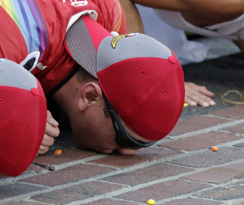 Kyle Busch kisses the yard of bricks at Indianapolis Motor Speedway after a dominant performance Sunday.