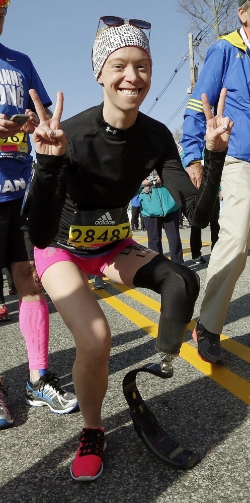 FILE - In this April 18, 2016, file photo, Boston Marathon bombing survivor Adrianne Haslet poses at the starting line in Hopkinton, Mass., before running in the 120th Boston Marathon. On Sunday, July 24, 2016, Davis reached the summit of Volcan Cayambe, Ecuador's third-highest mountain, with a team of climbers from the Range of Motion Project. The nonprofit group helps provide prosthetic limbs to people around the world who don't have access to them. (AP File)