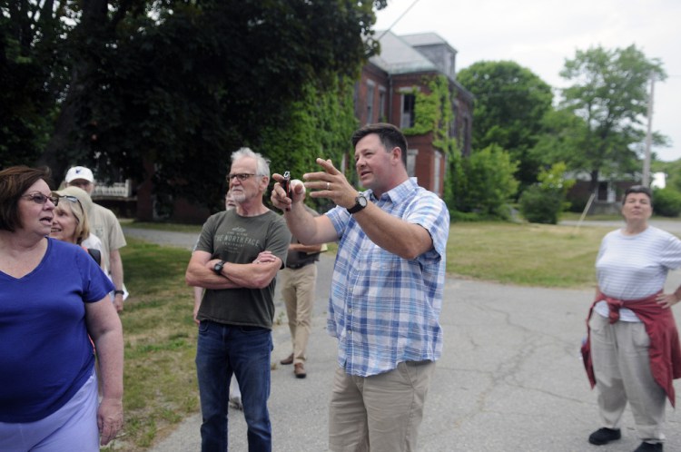 Matt Morrill, center, describes to several residents what he would like to do with the buildings at the Stevens School complex in this June file photo.