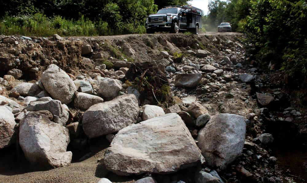 UPPER ENCHANTED TWP.,  ME-  July 25: A delegation of landowners, legislators and other officials travel on the Old Spencer Road in Upper Enchanted Tsp. past an eroded and washed- out section caused by a storm last month on Monday , July 25, 2016. (Photo by David Leaming/Staff Photographer)