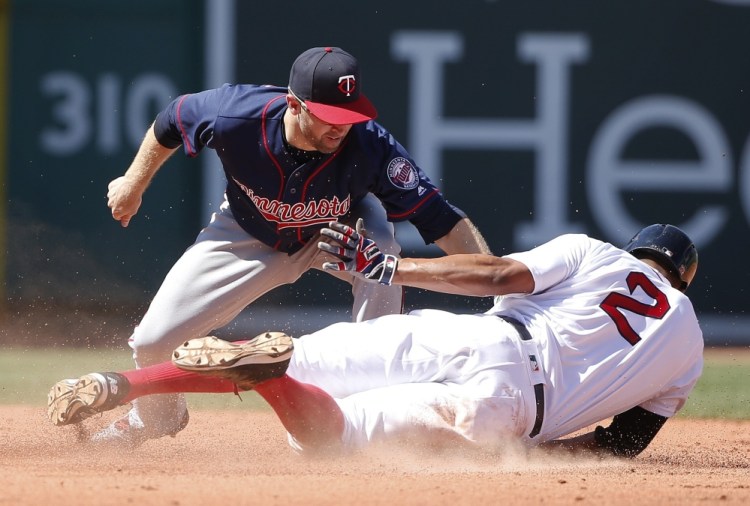 Minnesota's Brian Dozier, left, misses the tag as Boston's Xander Bogaerts (2) steals second base during the fifth inning.