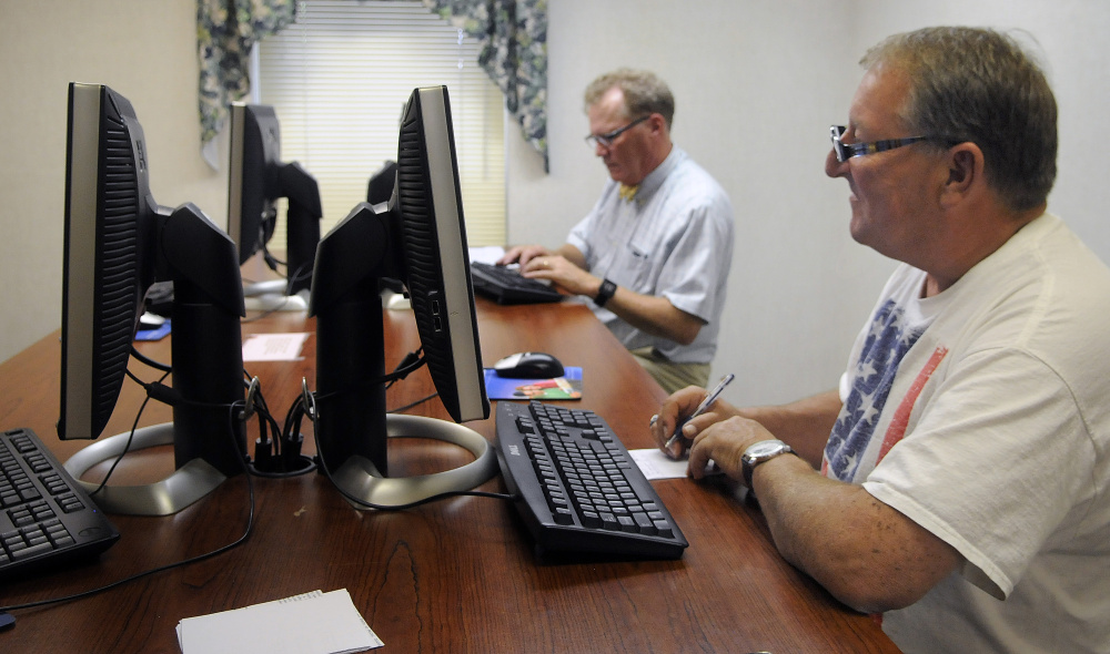 Walter Stanley, right, of Connecticut, and Gardiner attorney Bruce Williams research deeds Monday at the Kennebec County Registry of Deeds, which recently relocated to 77 Winthrop St. in Augusta.