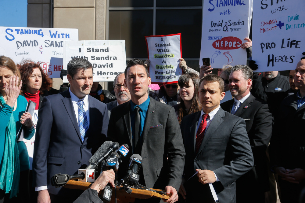 David Daleiden, center, one of the two anti-abortion activists who were charged with tampering with government evidence, speaks to media and supporters after turning himself in to authorities on Feb. 4 in Houston. The charges against him and Sandra Merritt were dismissed Tuesday.