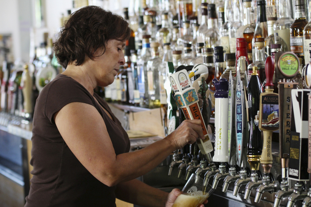 Bartender Catherine Pierluissi pulls a Ballast Point tap handle at Sugar Maple in Milwaukee, where there are at least 60 beers on tap.