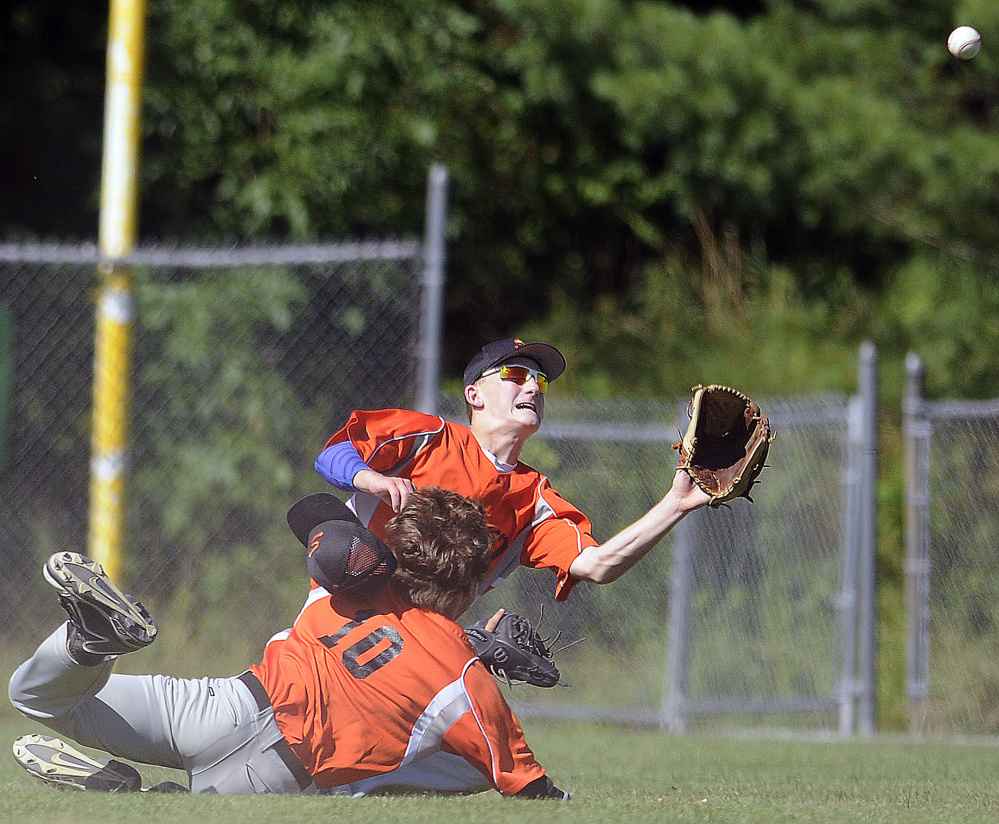 Evan Bess of Skowhegan, right, prepares to catch a short fly ball after colliding with teammate Adam Turcotte in right field during the 11-3 loss to Yankee Ford in the American Legion baseball state tournament Wednesday at Augusta.