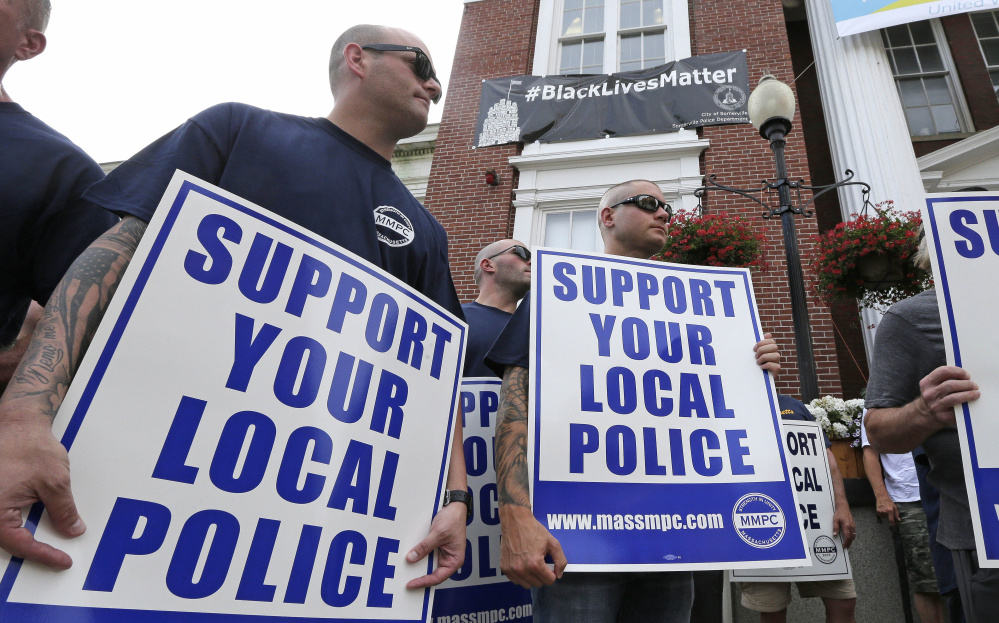 Police officers and their supporters picket Thursday outside Somerville, Mass., City Hall, where Mayor Joe Curtatone maintains it is not anti-law enforcement.