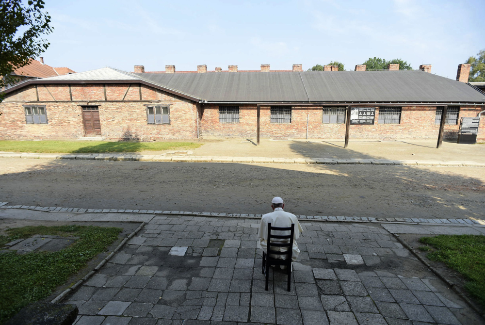 Pope Francis prays Friday at the Nazi German death camp of Auschwitz-Birkenau in Oswiecim, Poland, where Adolf Hitler's forces killed more than 1 million people, most of them Jews, during Worl War II.