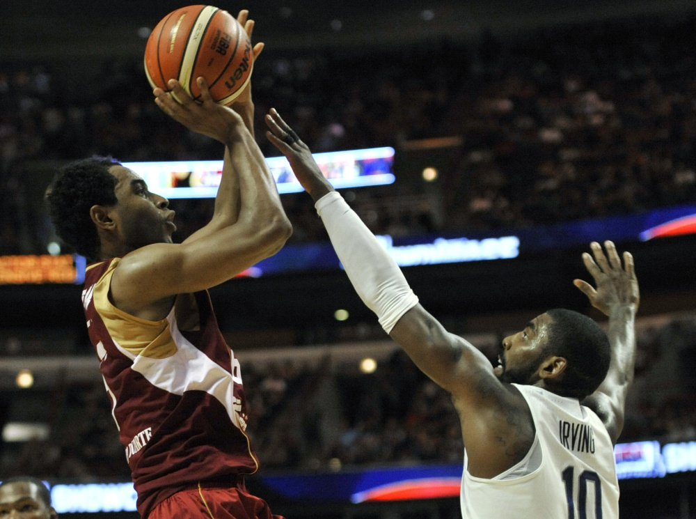 John Cox of Venezuela lofts a shot over Kyrie Irving of the United States during the first half of the U.S.' 80-45 victory Friday night in a men's basketball tuneup in Chicago before the Olympics.