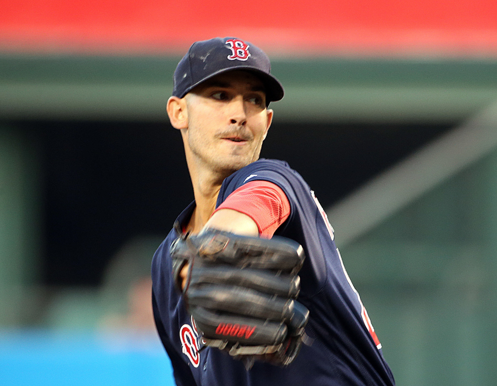 Boston's Rick Porcello pitches to the Angels in the first inning Friday night in Anaheim, Calif. Porcello pitched a complete game as the Red Sox won, 6-2.