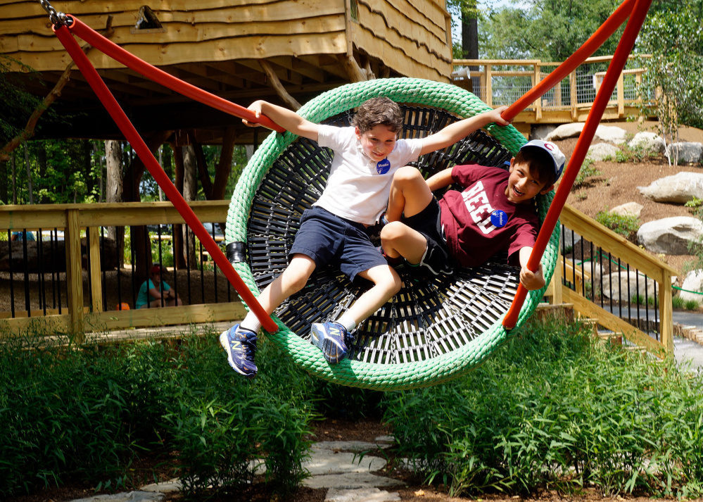 Zachary Abramovich, 7, and Reed Churchill, 6, swing on a new wicker swing at Discovery Museums in Acton, Mass. 