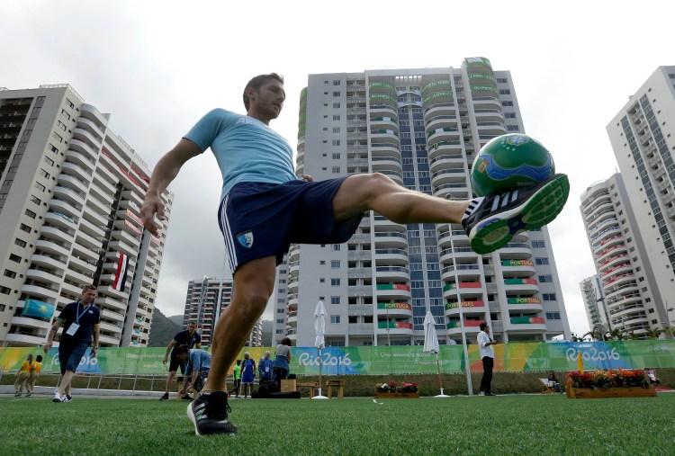 Argentine field hockey player Lucas Vila passes a soccer ball at the Olympic athletes village in Rio de Janeiro, Brazil, on Sunday. The Olympics are scheduled to open Aug. 5. (Associated Press/Charlie Riedel)