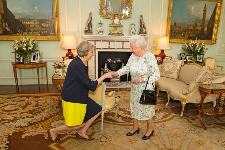 Queen Elizabeth II welcomes Theresa May at the start of an audience in Buckingham Palace, where she invited the former home secretary to become prime minister and form a new government. May last week invited President Trump for a state visit, putting the Queen in an awkward position.

