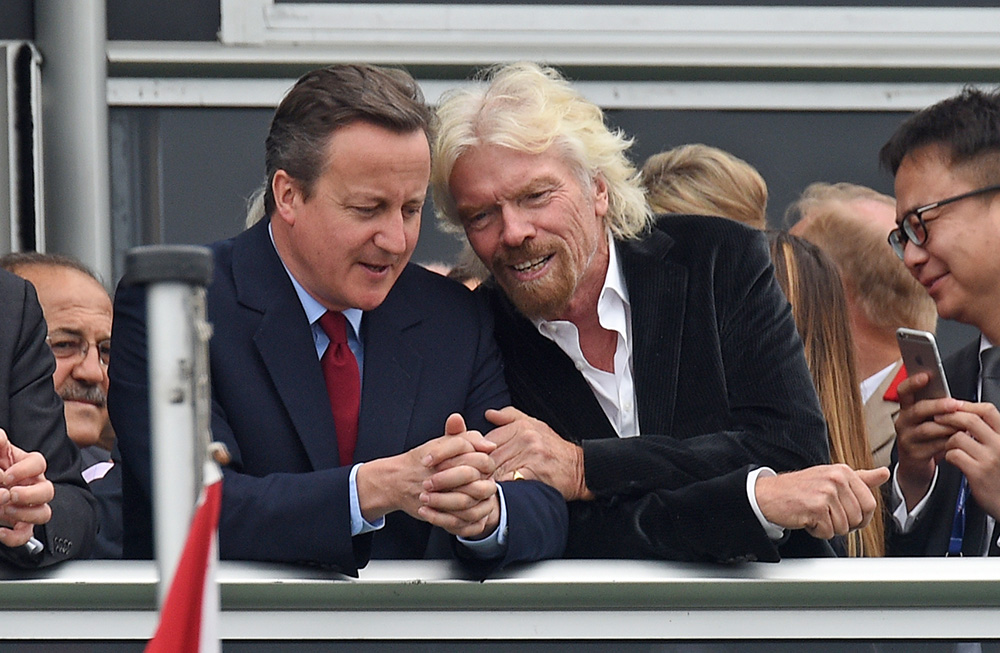 Britain's Prime Minister David Cameron and Virgin boss Richard Branson talk at the Farnborough International Airshow in Farnorough, south England, Monday. Andrew Matthews / PA via AP