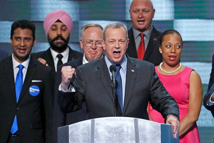 Gen. John Allen (Ret.) stands with veterans as he speaks during the final day of the Democratic National Convention in Philadelphia on Thursday. Scott Applewhite/Associated Press