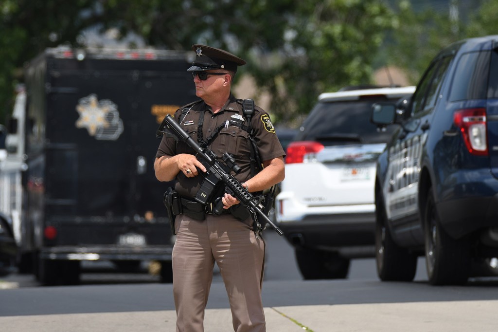 Sheriff's Deputy Guy Puffer stands watch outside the Berrien County Courthouse after Monday's shooting. A jail inmate trying to escape grabbed a gun from an officer, killing two bailiffs before he was fatally shot by other officers.
Mark Parren via AP