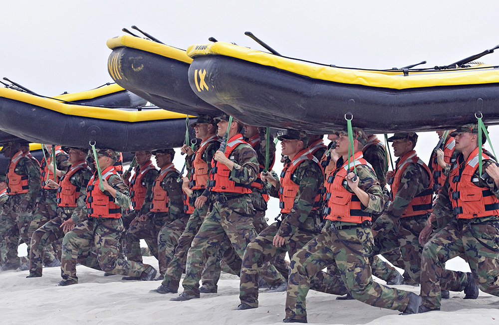 Navy SEAL trainees carry inflatable boats at the Naval Amphibious Base Coronado in Coronado, Calif. in May 2009. Denis Poroy/Associated Press