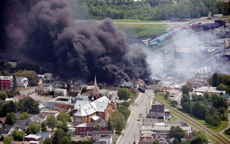 Smoke rises from oil tanker cars after they derailed in downtown Lac Megantic, Quebec, in 2013. The derailment killed 47 people and burned 30 buildings in the town's center. Paul Chiasson/The Canadian Press via AP
