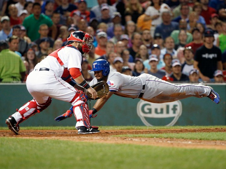 Texas' Elvis Andrus scores on a double as Boston's Sandy Leon waits for the throw during the sixth inning Tuesday.    Associated Press/Michael Dwyer