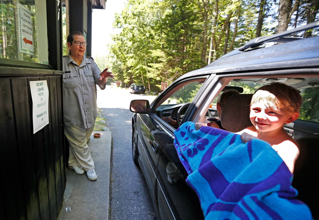 Sarah Crosby speaks to a visitor heading to the beach at Reid State Park. She has worked the entryway to Maine's oldest state-owned beach for 44 years, and has no plans to stop.
Associated Press/Robert F. Bukaty