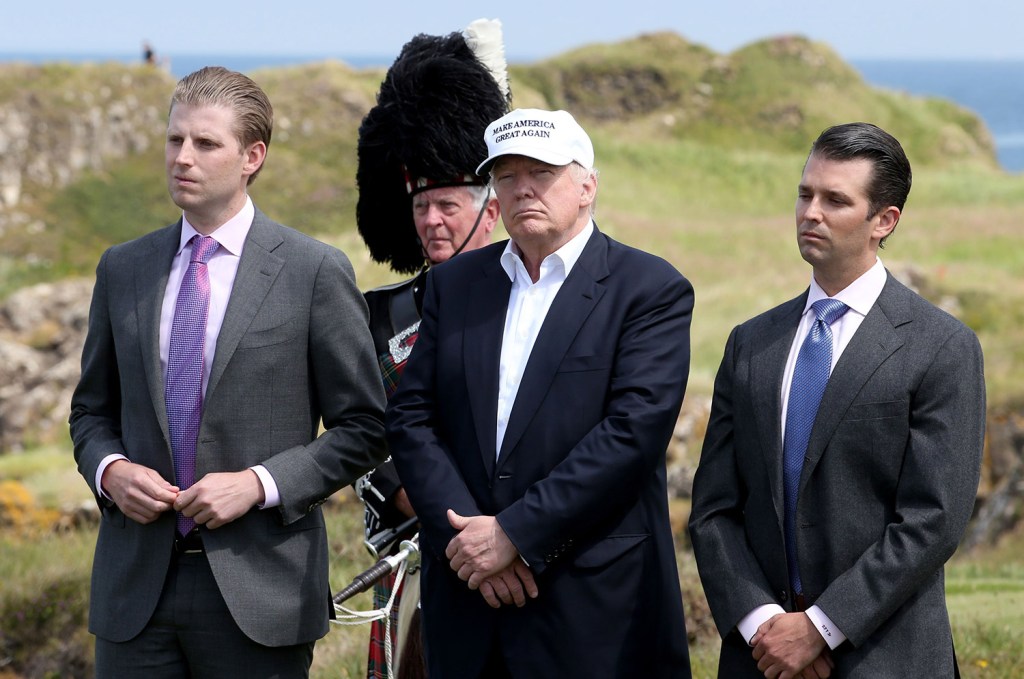Eric Trump, left, seen June 24 in Scotland with his father and his brother, Donald, told The Washington Post that his father gives "millions and millions and millions" of his own money to charity, but provided no details.
