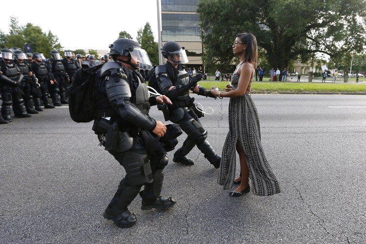 A demonstrator protesting the shooting death of Alton Sterling is detained by law enforcement near the headquarters of the Baton Rouge Police Department in Baton Rouge, Louisiana, on Saturday.