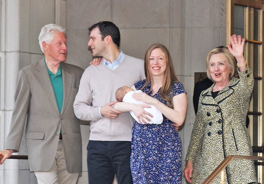 Chelsea Clinton holds her newborn son, Aidan, her second child, as she leaves Lenox Hill Hospital with her husband, Marc Mezvinsky; her father, former President Bill Clinton and Democratic presidential candidate Hillary Clinton in New York. William Regan / Associated Press