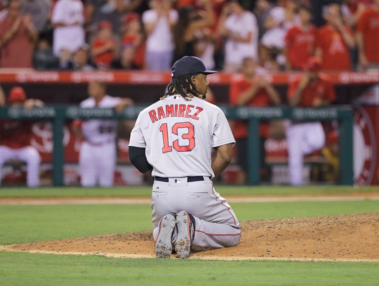 Boston Red Sox first baseman Hanley Ramirez kneels on the mound in the 9th inning after his bad throw to home plate allowed the Angels to score 2 runs and walk off with a 2-1 win against the Sox Thursday night in Anaheim, Calif. Jae C. Hong/Associated Press