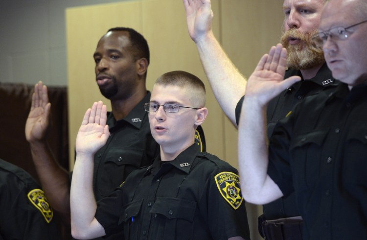 Chayce Steffiare, 21, of South Berwick is sworn in Friday as a York County Jail corrections officer. Staff shortages often mean mandatory overtime, which affects morale.