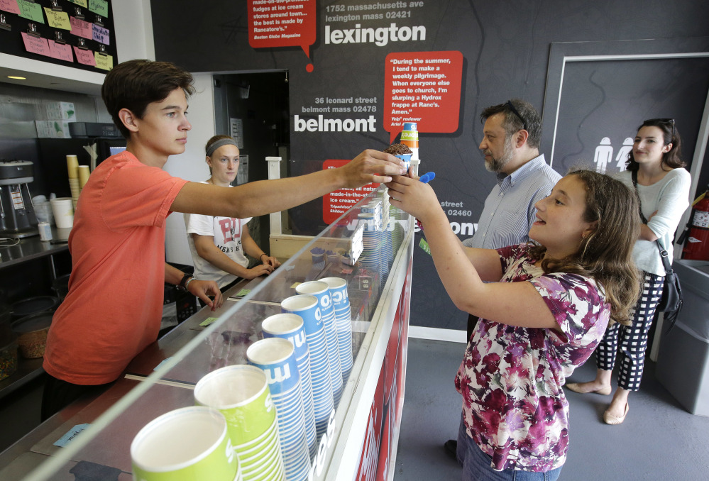 Nick Tzannes serves ice cream to Magnolia Keller-Deutsch on Tuesday at Rancatore's Ice Cream & Yogurt, a pop-up in Newton, Mass. Entrepreneurs and cities are increasingly embracing the pop-up concept.