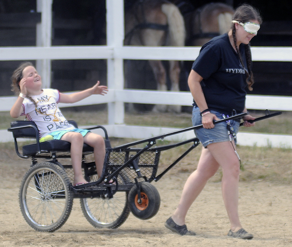 Meka Morrison, 7, reacts to being a little off course while being towed by her mother, Jennifer Morrison of Wayne, during the Back Seat Driver contest at the 106th Monmouth Fair on Sunday.