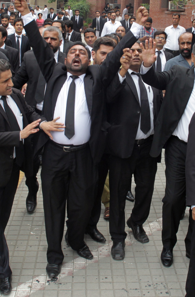 Pakistani lawyers hold a demonstration to condemn a suicide bombing in Quetta that killed dozens of people and wounded many more in Lahore, Pakistan, Monday.