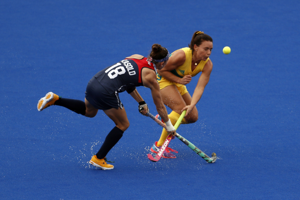 The United States' Michelle Kasold, left, fights for the ball with Australia's Georgie Parker during a women's field hockey match Monday in Rio de Janeiro