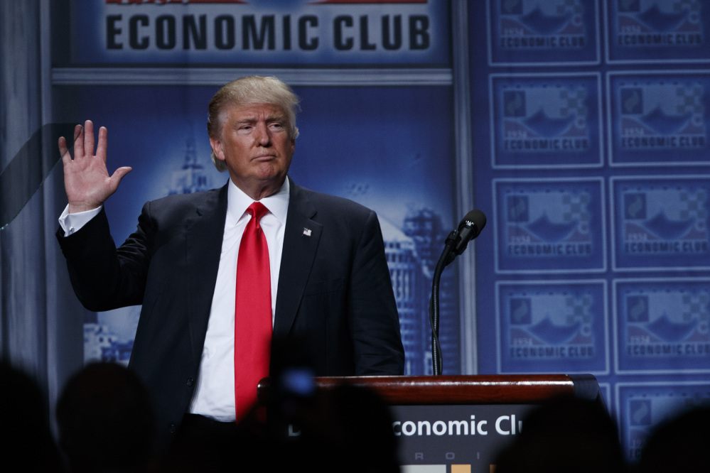 Republican presidential candidate Donald Trump waves after delivering an economic policy speech to the Detroit Economic Club on Monday in Detroit.  Among the inaccuracies in the speech: He wrongly accused Hillary Clinton of proposing to increase middle-class taxes.