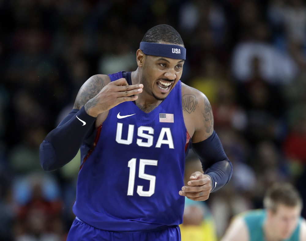 Carmelo Anthony reacts to a score against Australia during Wednesday's game. Anthony, a four-time Olympian, became the top career scorer for the U.S. men's team during the game.