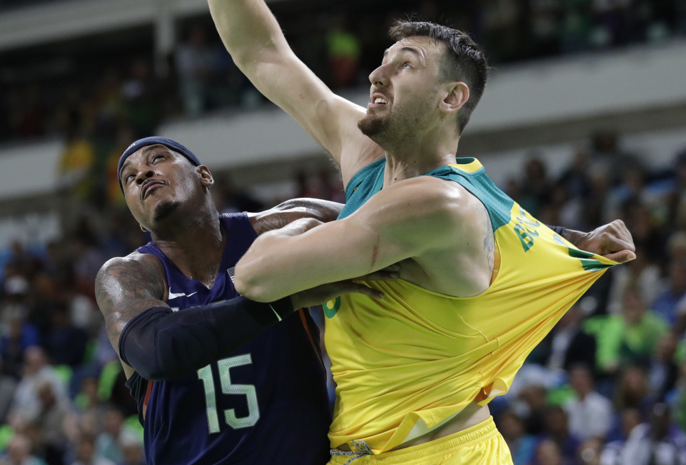 Carmelo Anthony of the U.S. (15) and Australia's Andrew Bogut (6), both NBA players, jockey for position during Wednesday's game. Anthony became the all-time leading U.S. scorer in the Olympics during the game.