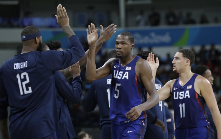 Kevin Durant (5) celebrates with teammates after the U.S. win over Australia on Wednesday in men's basketball at the Summer Olympics in Rio de Janeiro. The Americans' 98-88 win was their toughest game so far in the tournament