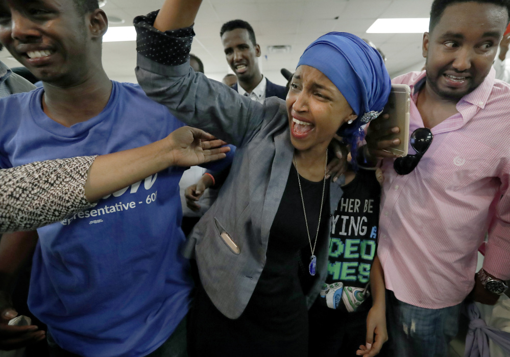 Somali activist Ilhan Omar is greeted by supporters Tuesday in Minneapolis. Omar defeated 22-term Rep. Phyllis Kahn in the heavily Democratic Minneapolis district.