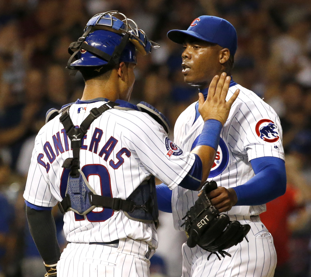 Chicago closer Aroldis Chapman celebrates with catcher Willson Contreras after the Cubs defeated the Los Angeles Angels 3-1 on Wednesday.