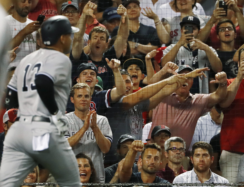 Alex Rodriguez gets an earful from the Boston fans as he heads back to the dugout after flying out as a pinch hitter in the seventh inning Wednesday night. Rodriguez is playing in his last series in Boston.