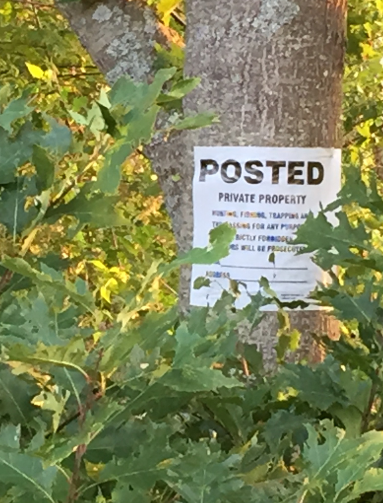 A sign posted on private property on Bowery Beach Road in Cape Elizabeth warns that hunting, fishing, trapping and otherwise trespassing is prohibited.